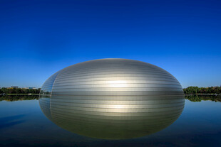 银色圆建筑倒影于水面