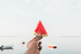 海边手持西瓜的惬意瞬间