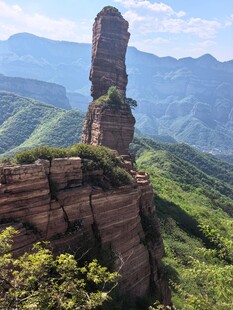 奇峰屹立于青山绿野间