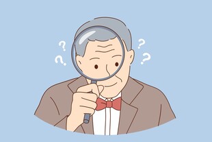 老人手持放大镜疑惑观察