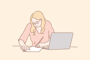 女性伏案使用电脑与书写