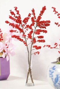 红色仿真花枝插于花瓶中