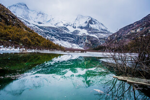 雪山下的静谧碧绿湖水