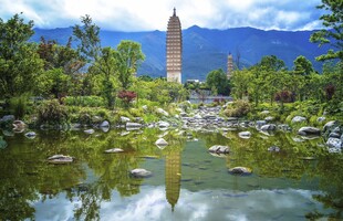 山间孤塔映于碧水绿植间