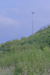 山坡草地与高耸灯杆